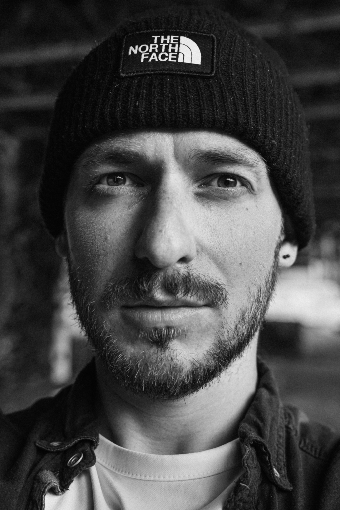 Portrait of a man with a beard wearing a beanie.