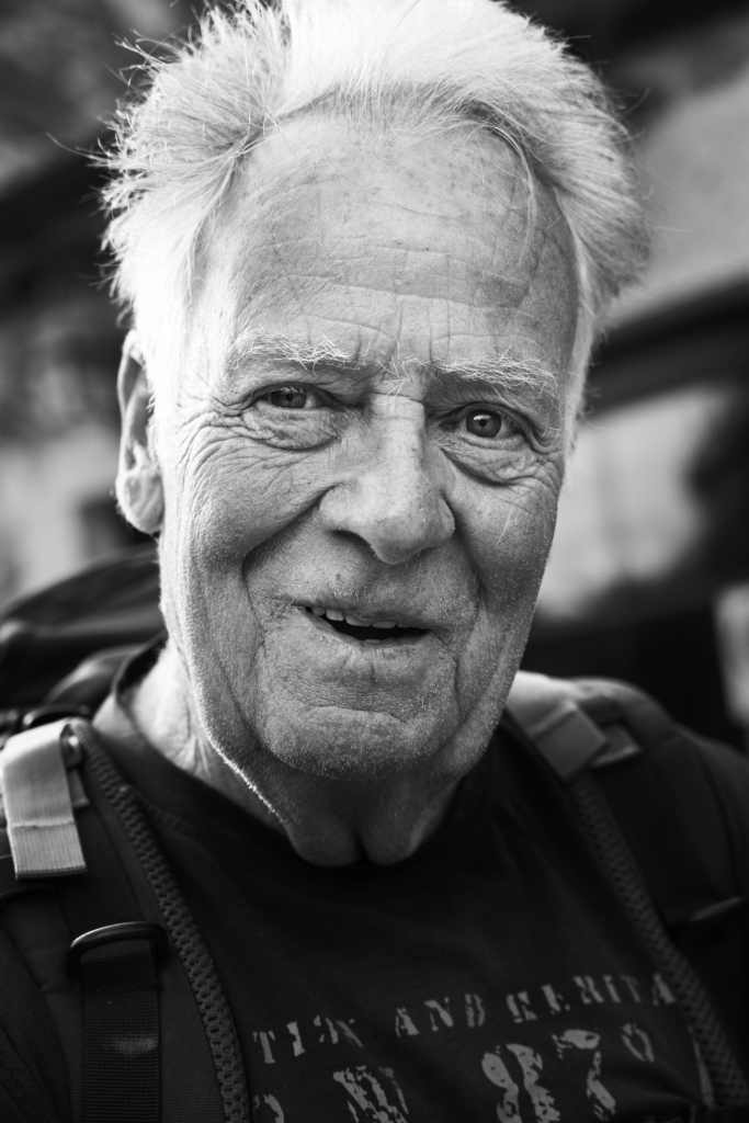 Portrait of an older man with thinning hair, neutral expression.
