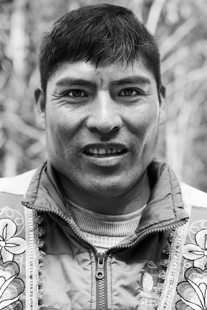Portrait of a young man smiling with short hair.