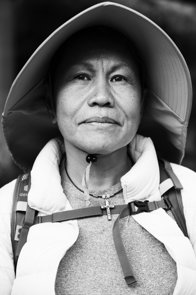 Portrait of a woman wearing a hat with a thoughtful expression.
