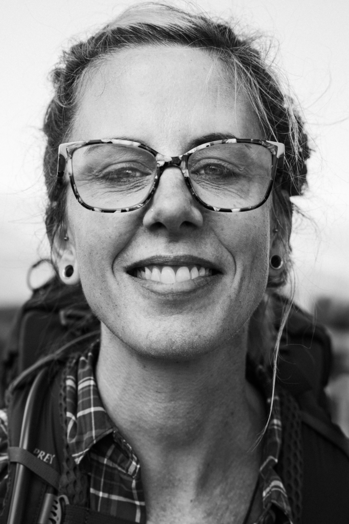 Portrait of a smiling woman wearing glasses.