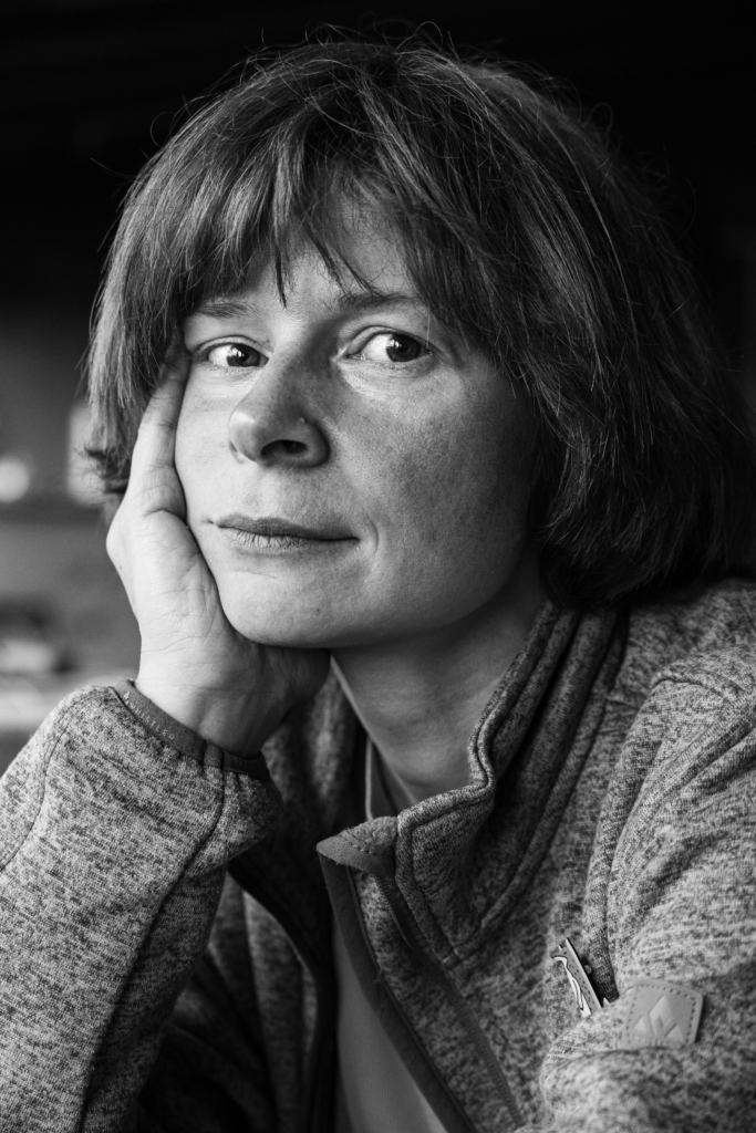 Portrait of a woman with short hair and a neutral expression.