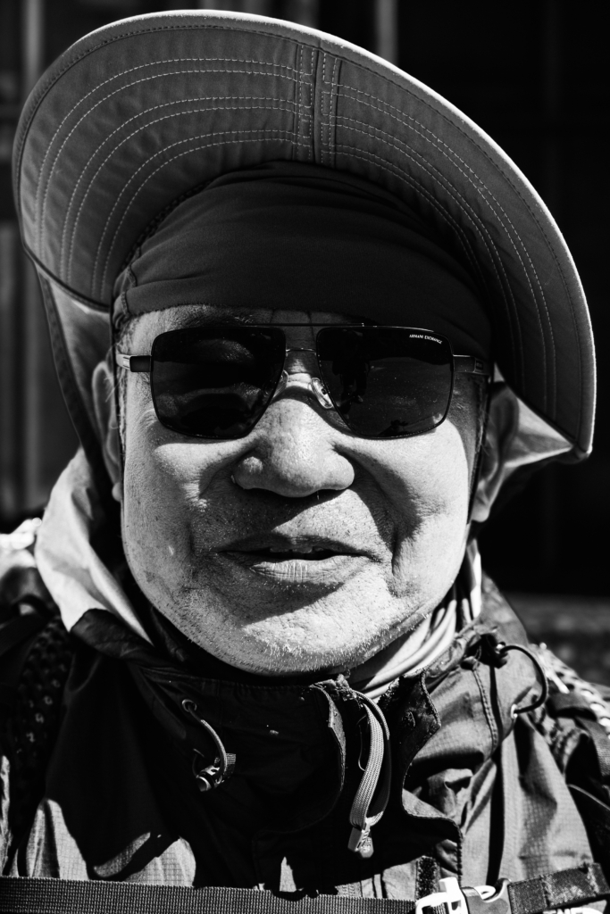 Portrait of a man wearing a hat with a thoughtful expression.