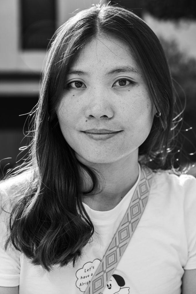 Portrait of a woman with long straight hair, slight smile.